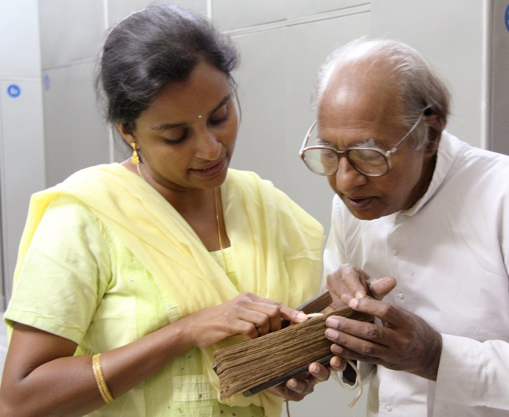 Scholar of Old Malayalam and Malayalam Garshuni, Fr. George Kurukkoor and historian Dr. Susan Thomas translate a bound, palm-leaf manuscript