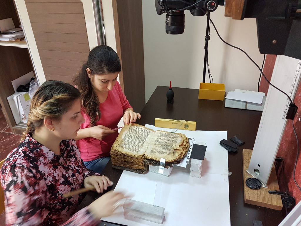 Technicians Rita and Myriam cleaning and digitizing the manuscripts of the Chaldean Patriarch of Babylon collection, moved from Baghdad to Erbil