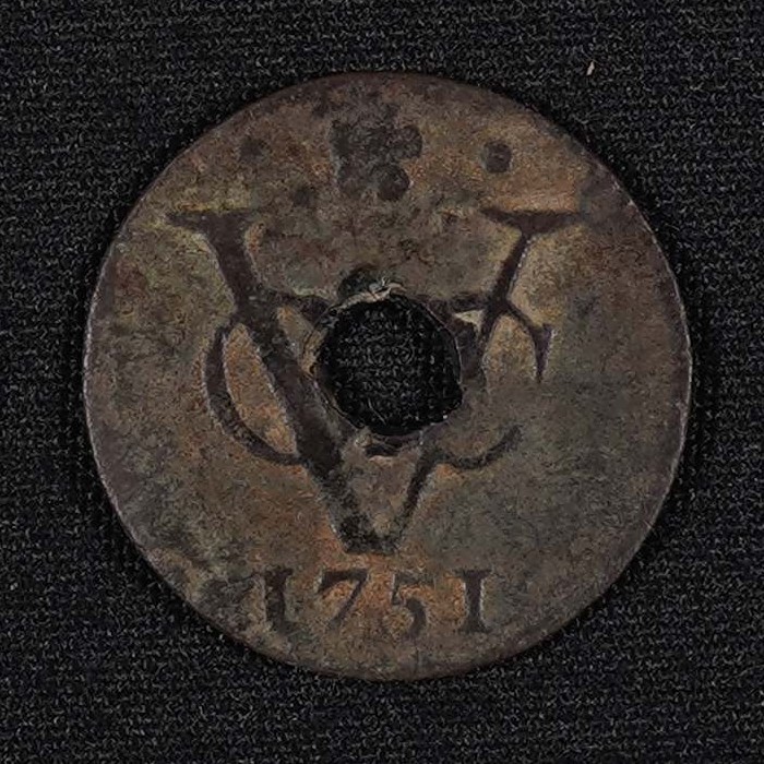 18th-century Dutch East India Company coin attached to a palm-leaf manuscript, featuring the VOC (Vereenigde Oostindische Compagnie) monogram and 1751 date of production (DKA 003 00022)