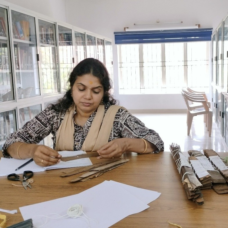 Dr. Ushus K. Unnikrishnan, a researcher in the DiPiKA Project, surveying the manuscripts of the Tantra Vidyā Pīṭham collection in Aluva. Photo: Hugo David (2024)